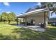 Spacious covered patio perfect for outdoor entertaining, surrounded by a lush green lawn at 5335 Canoe Creek Rd, St Cloud, FL 34772