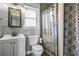 Well-lit bathroom with a shower, updated sink and cabinet, and modern fixtures at 5335 Canoe Creek Rd, St Cloud, FL 34772