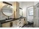 Modern bathroom featuring double sinks, granite countertops, and shiplap walls at 5335 Canoe Creek Rd, St Cloud, FL 34772