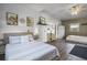 Spacious bedroom with shiplap walls, ceiling fan, and two beds at 5335 Canoe Creek Rd, St Cloud, FL 34772