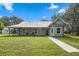 Charming single-story home featuring a metal roof, covered porch, and lush lawn at 5335 Canoe Creek Rd, St Cloud, FL 34772