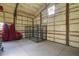 Spacious garage with metal cage, foam insulation, and bright overhead lighting at 5335 Canoe Creek Rd, St Cloud, FL 34772