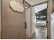 Hallway leading to a bedroom with a board and batten accent wall, featuring a sliding barn door to the laundry room at 5335 Canoe Creek Rd, St Cloud, FL 34772