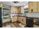 Modern kitchen featuring wooden cabinets, black countertops, and stainless steel appliances at 5335 Canoe Creek Rd, St Cloud, FL 34772