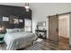 Well-decorated main bedroom featuring hardwood floors, a barn door, and natural light at 5335 Canoe Creek Rd, St Cloud, FL 34772