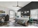 Stylish primary bedroom featuring a dark accent wall, hardwood floors, and natural light at 5335 Canoe Creek Rd, St Cloud, FL 34772