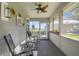 Enclosed porch with rocking chairs and views of the green yard at 5335 Canoe Creek Rd, St Cloud, FL 34772