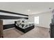 This bedroom features a black and white striped accent wall and carpeted flooring at 545 Jerry Ln, Haines City, FL 33844