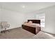 Cozy bedroom with carpeted floor, window with blinds and a wooden bed frame at 545 Jerry Ln, Haines City, FL 33844