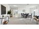 Bright dining area with carpeted floors, stylish furniture, and view to a backyard at 545 Jerry Ln, Haines City, FL 33844