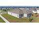 A view of the backyard with a lawn and a patio, and the side of the house at 545 Jerry Ln, Haines City, FL 33844
