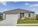 Charming single-story home with a two-car garage, well manicured lawn, and landscaped front yard at 545 Jerry Ln, Haines City, FL 33844