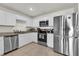 Bright kitchen with stainless steel appliances and tile floors at 545 Jerry Ln, Haines City, FL 33844