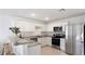 Modern kitchen with stainless steel appliances, white cabinetry, and breakfast bar seating at 545 Jerry Ln, Haines City, FL 33844