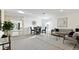 Open-concept living room with carpeted floors, modern furniture, and lots of natural light at 545 Jerry Ln, Haines City, FL 33844