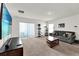 Bright living room with sliding glass doors and view of the kitchen at 545 Jerry Ln, Haines City, FL 33844