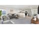 Open living room featuring kitchen with bar seating, grey sofa, and modern decor at 545 Jerry Ln, Haines City, FL 33844