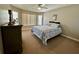 Bedroom with large window and a queen bed with a blue patterned comforter set at 546 Nogales Ct, Kissimmee, FL 34758