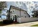 Side view of a well-maintained two-story home with a fenced yard and lush landscaping at 546 Nogales Ct, Kissimmee, FL 34758