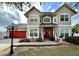 Beautiful two-story home featuring a red front door with brick accents and a red two-car garage door at 546 Nogales Ct, Kissimmee, FL 34758