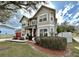 Inviting two-story home with a red garage door and a beautifully landscaped front yard at 546 Nogales Ct, Kissimmee, FL 34758