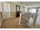 Upstairs hallway with carpet flooring and view of the staircase, front door, and foyer at 546 Nogales Ct, Kissimmee, FL 34758