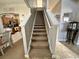 Carpeted staircase leading to the upper level of the home with wood railings at 546 Nogales Ct, Kissimmee, FL 34758