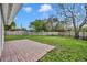 Large, fenced backyard with brick patio, providing ample outdoor space and privacy at 5844 Bamboo Dr, Orlando, FL 32807