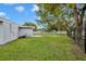 A lush backyard with a well-kept lawn, a brick patio, and a secure fence for privacy at 5844 Bamboo Dr, Orlando, FL 32807