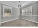 Sunlit bedroom with tiled flooring, modern light fixture, and neutral color palette at 5844 Bamboo Dr, Orlando, FL 32807