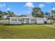 Charming home showcasing a well-manicured lawn, light gray exterior paint, and decorative front door at 5844 Bamboo Dr, Orlando, FL 32807