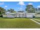 Charming home showcasing a well-manicured lawn, light gray exterior paint, and decorative front door at 5844 Bamboo Dr, Orlando, FL 32807