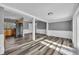 Open living room with gray walls, white trim, and wood-look floors, providing a modern and spacious feel at 5844 Bamboo Dr, Orlando, FL 32807