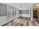 Bright and airy living area with french doors leading to the outdoors, featuring modern flooring at 5844 Bamboo Dr, Orlando, FL 32807