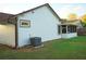 Exterior view of the home's well-maintained siding, screened-in porch, and efficient AC unit at 6501 Abercrombie Ct, Orlando, FL 32835