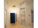 Bright foyer featuring tile flooring, a modern light fixture, and a built-in shelving unit at 6501 Abercrombie Ct, Orlando, FL 32835