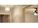 Hallway with neutral walls and a decorative light fixture at 6501 Abercrombie Ct, Orlando, FL 32835