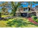 Beautiful backyard featuring a lush green lawn and mature trees offering shade, complemented by mulch landscaping at 7217 Dr Phillips Blvd, Orlando, FL 32819