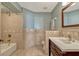 Bathroom with decorative tile, framed mirror, vanity with dark wood drawers, and shower-tub combo at 7217 Dr Phillips Blvd, Orlando, FL 32819