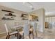 Bright dining room with modern glass table and chairs with floating shelves at 7217 Dr Phillips Blvd, Orlando, FL 32819