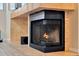 Close up of stone fireplace with lit fire and decorative mantle at 7217 Dr Phillips Blvd, Orlando, FL 32819