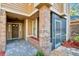 Welcoming front porch featuring brick columns and a screened-in entry at 7217 Dr Phillips Blvd, Orlando, FL 32819