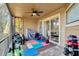 Outdoor patio with work out equipment, colorful floor coverings, ceiling fan, and sliding glass doors at 7217 Dr Phillips Blvd, Orlando, FL 32819