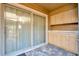 Screened-in porch featuring cabinetry, a large sliding door, and tiled flooring at 7217 Dr Phillips Blvd, Orlando, FL 32819