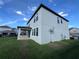 Rear exterior view showing a spacious backyard and a covered patio with a built-in grill at 7606 Loon Ave, Winter Garden, FL 34787