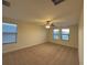 Spacious bedroom features neutral carpet, a ceiling fan, and large windows with blinds for natural light at 7606 Loon Ave, Winter Garden, FL 34787