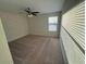 Bedroom features a ceiling fan, neutral carpet, and a bright window at 7606 Loon Ave, Winter Garden, FL 34787