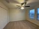 Bedroom featuring two bright windows with blinds and closet at 7606 Loon Ave, Winter Garden, FL 34787