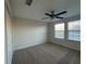 Bedroom with neutral carpet, ceiling fan, a closet and natural light from multiple windows at 7606 Loon Ave, Winter Garden, FL 34787