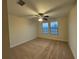 Bedroom with a ceiling fan, carpet, and two bright windows with blinds at 7606 Loon Ave, Winter Garden, FL 34787